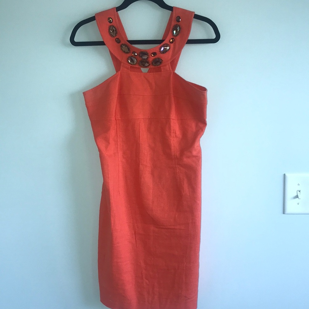 orange cocktail dress with detailing around neck